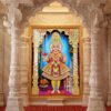 Bhagwan Swaminarayan standing in colourful traditional attire inside an ornate golden temple arch with floral offerings.