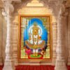 Swaminarayan Maharaj standing in colourful traditional garments beneath an ornate gold arch with a blue halo.