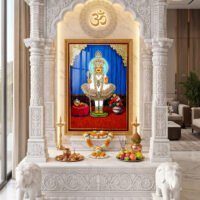 Swaminarayan Maharaj in elaborate gold and red devotional attire, framed by ornate temple pillars and flower offerings.