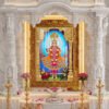 Beautiful Lord Swaminarayan murti adorned with golden jewelry, flower garlands and royal traditional dress with blue divine halo.