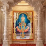 Lord Swaminarayan beautiful divine murti dressed in royal blue poshak with golden ornaments and magnificent temple architecture.