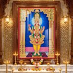 Lord Swaminarayan standing in divine pose wearing yellow traditional poshak and golden crown inside a beautifully decorated temple.